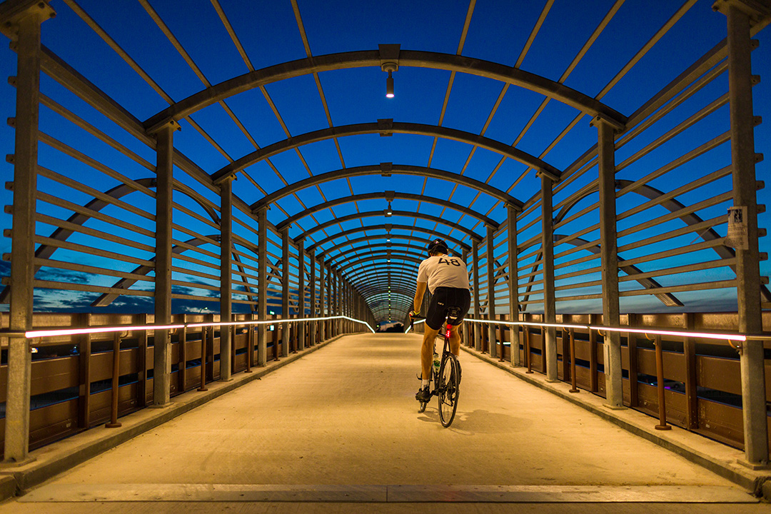 Biker riding on the 183 trail pedestrian bridge